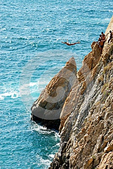 Group of cliff divers in free fly, Acapulco, Mexico.
