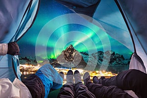 Group of climber are inside camping with aurora borealis over mo