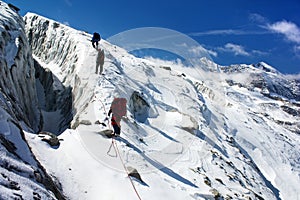 Group of climbers on rope on glacier