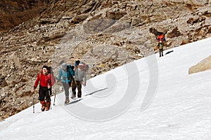 Group of Climbers walking on Snow Nepalese Porter on Background