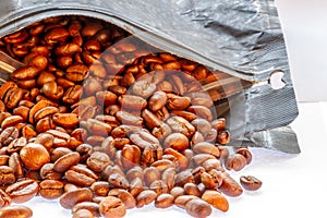 A group of coffee beans that have been roasted, poured from packaging with good circulation, ready to be grinded and made drinks
