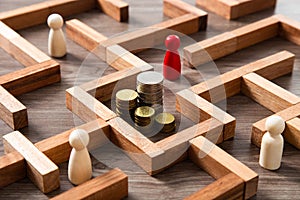 Group of coins heaps in the maze game built by wood blocks, find a way to money resource concept