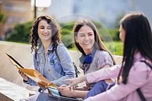 Three collage girls studying outside