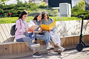 Three collage girls studying outside