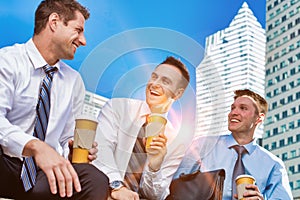 Group of colleagues sitting and talking while drinking coffee after work