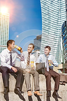 Group of colleagues sitting and talking while drinking coffee after work