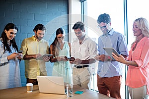Group of colleagues using tablet computer