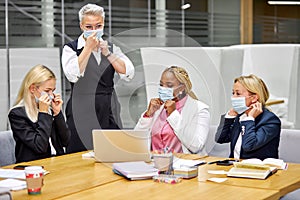 Group of colleagues wearing masks before coworking in the office