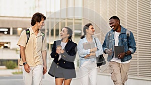 Group of college friends walking outdoors in university campus