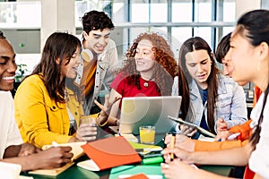 Group of college people studying together on cafeteria table at campus