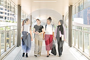 Group of college student friends walking together in hall