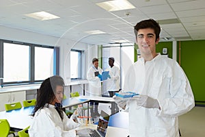 Group Of College Students In Science Class With Experiment