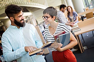 Group of college students studying at library