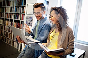 Group of college students studying in the school library.