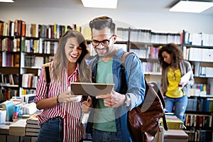 Group of college students studying in the school library.