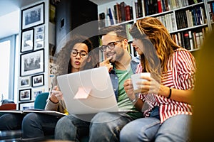 Group of college students studying in the school library.