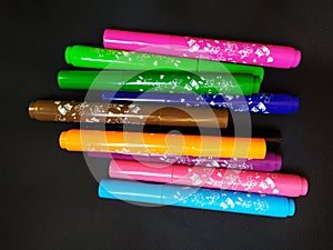 Group of Colored Markers Isolated on a Black Background.
