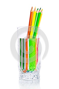 Group of colored pencils in a glass cup