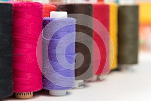 Group of colored sewing threads as colorful background