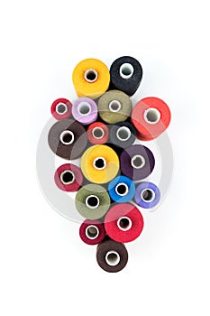 Group of colored thread coils on white background, sewing and tailoring