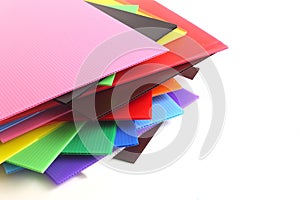 Group of colorful corrugated plastic sheets on white