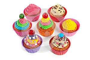 A group of colorful creamed decorated cupcakes