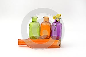Group of colorful empty transparent glass bottles