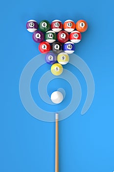 A group of colorful glossy billiard balls with numbers and a cue stick on a blue pool table