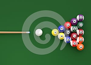 A group of colorful glossy billiard balls with numbers and a cue stick on a green pool table