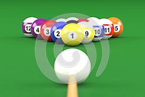 A group of colorful glossy billiard balls with numbers and a cue stick on a green pool table