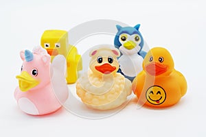 A group of colorful rubber ducks on an isolated white background