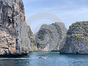 Sailboats in waters of Phuket PhiPhi islands, Thailand, with JamesBond Island in the background