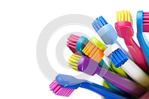 Group Of Colorful Toothbrushes In Cup Isolated