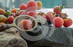 Group of Colorful variety of Fresh wild tomatoes Mini Cherry Tomatos on old wooden board background