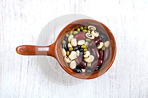 Group of colorful various beans in ceramic bowl