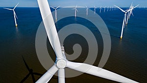 A group of colorful windmills floats gracefully on the ocean waters of Flevoland, Netherlands