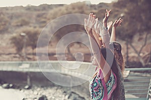 Group of coloured diverstiy clothes girls giving up hands enjoying the independence and freedom together, in friendship - love and