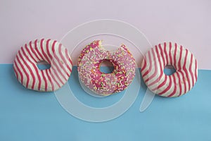 Doughnuts lies on pink and blue background