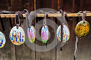 Group of colourful hand painted mixed necklaces and suvenirs displayed for sale at a traditional weekend market in Bucharest,