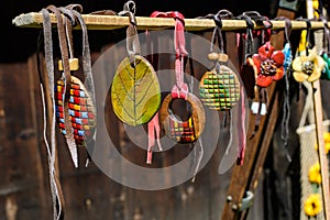 Group of colourful hand painted mixed necklaces and suvenirs displayed for sale at a traditional weekend market in Bucharest,