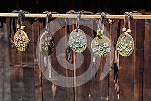 Group of colourful hand painted mixed necklaces and suvenirs displayed for sale at a traditional weekend market in Bucharest,