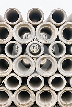 Group of concrete sewer pipes stacked at factory