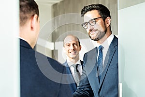 Group of confident business people greeting with a handshake at business meeting in modern office or closing the deal