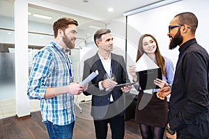 Group of confident business people on meeting with team leader