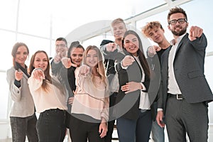 Group of confident young business people pointing at you