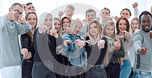 Group of confident young people pointing at you