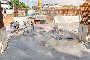Group of Construction worker with excavator heavy machine and cement truck for concrete pouring during commercial concreting