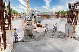 Group of Construction worker troweling wet concrete on a top of concrete beam new construction site