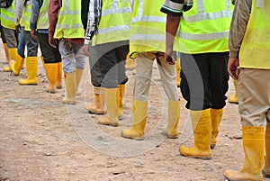 Group of construction workers assemble at the open space.