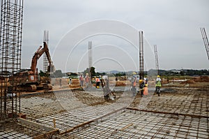 A group of construction workers casting floor slab